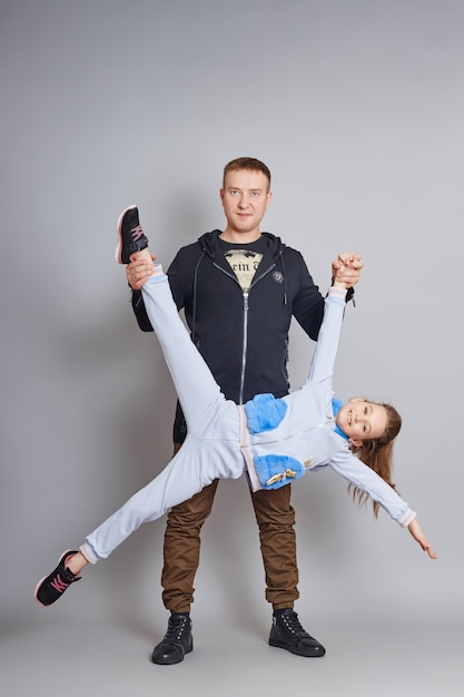 Father and daughter posing in trendy clothes