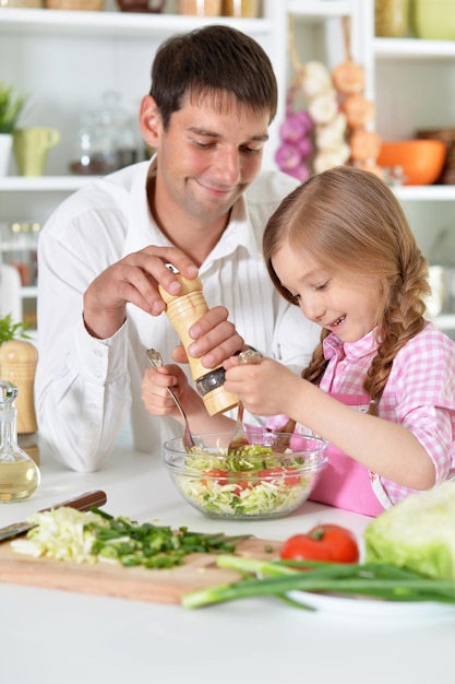 Father and daughter preparing salad