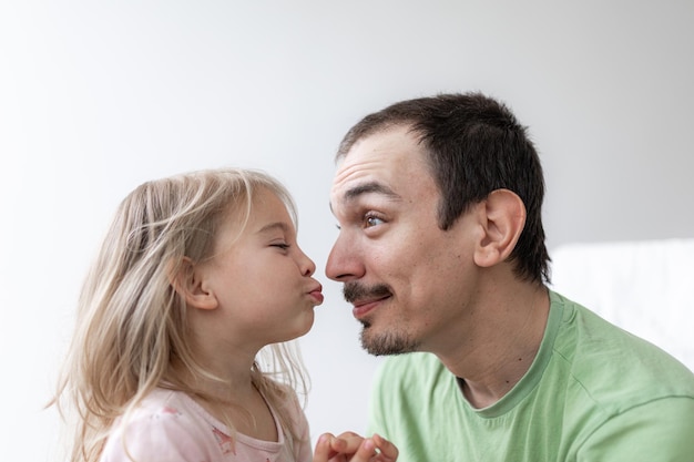 Father and daughter together daddy at home young caucasian man with his little girl
