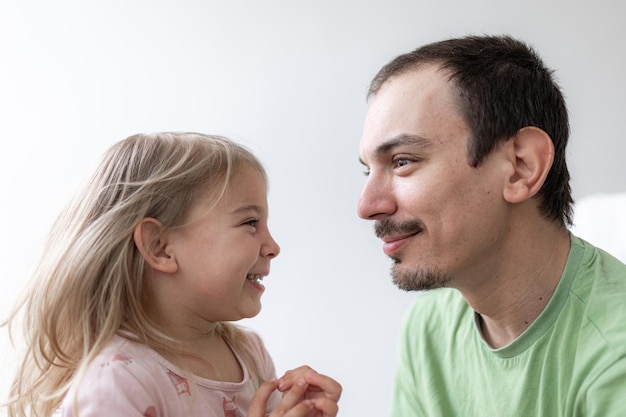 Father and daughter together daddy at home young caucasian man with his little girl