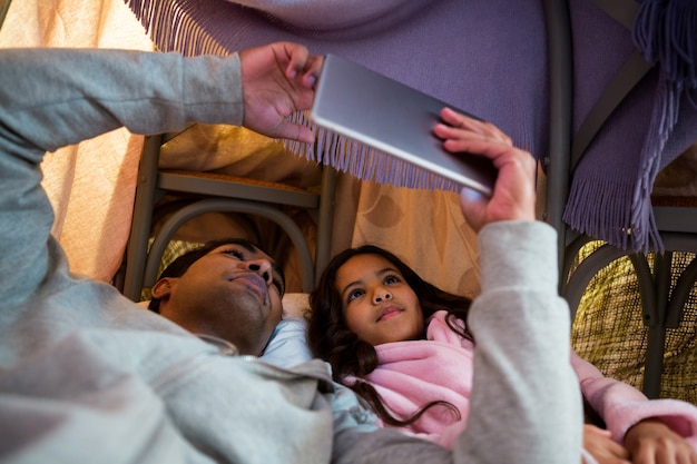 Father and daughter using digital tablet