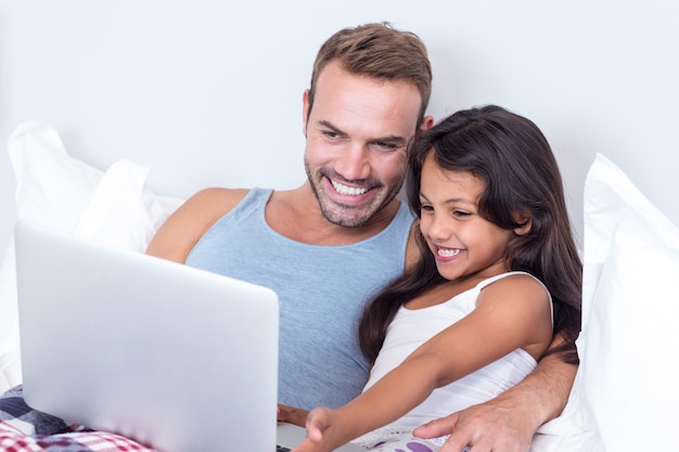 Father and daughter using laptop