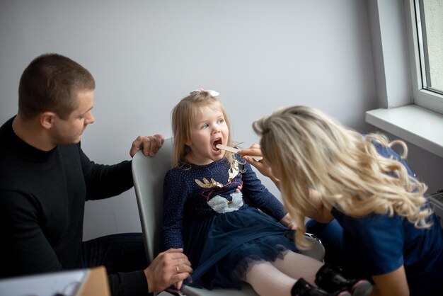 Father and daughter visiting pediatrician in medical clinic