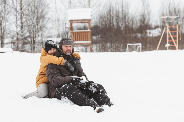 Father and daughter walking through snowy landscape family walk in the winter park