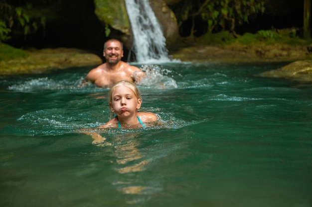 Father and daughter at a waterfall in the jungle.Turkey