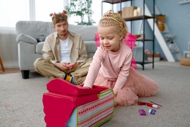 Father and daughter wearing fairies costume having fun