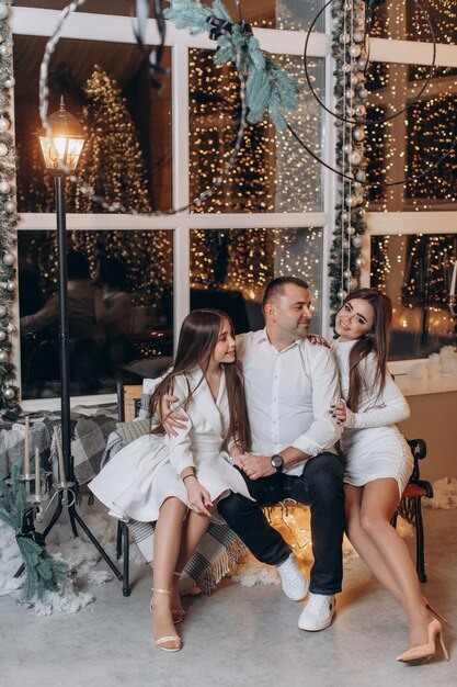 father and daughters near christmas tree