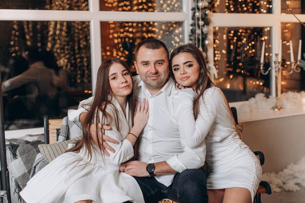 father and daughters near christmas tree