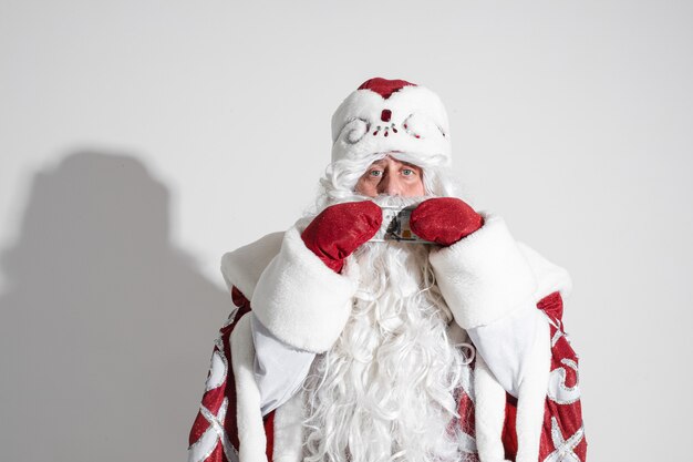 Father Frost with dollar banknote in hands.