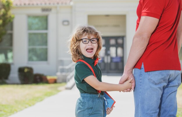 Father and funny excited son after school.