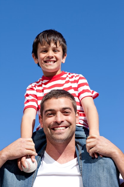 Father giving his son piggyback ride outdoors