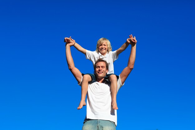 Father giving his son a piggyback ride