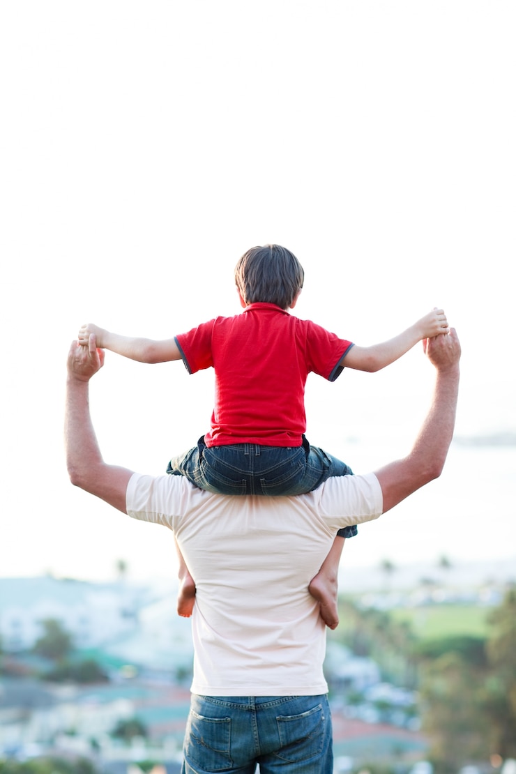 Photo father giving son piggyback ride