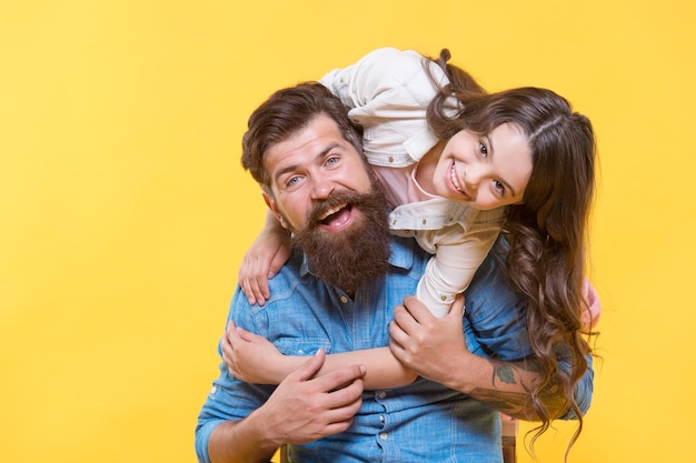 Father and happy little daughter having fun lovely hug concept