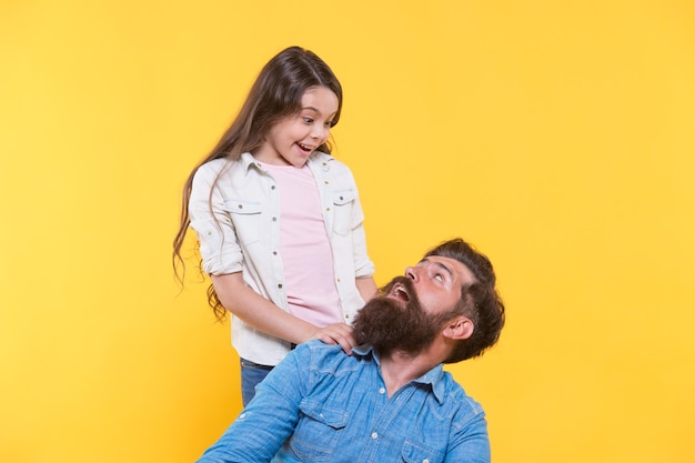 Father and happy little daughter having fun surprise concept