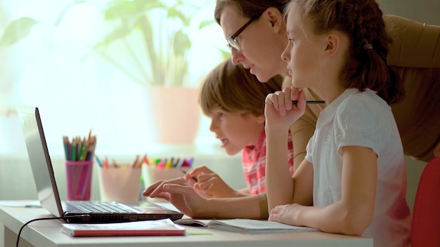 Photo father helping his kids to finish homework