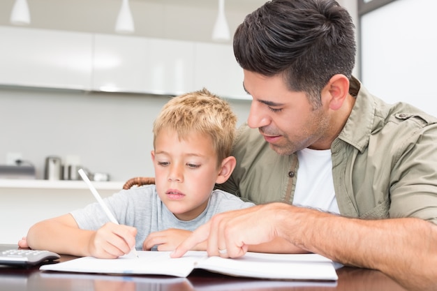 Father helping son with his math homework 