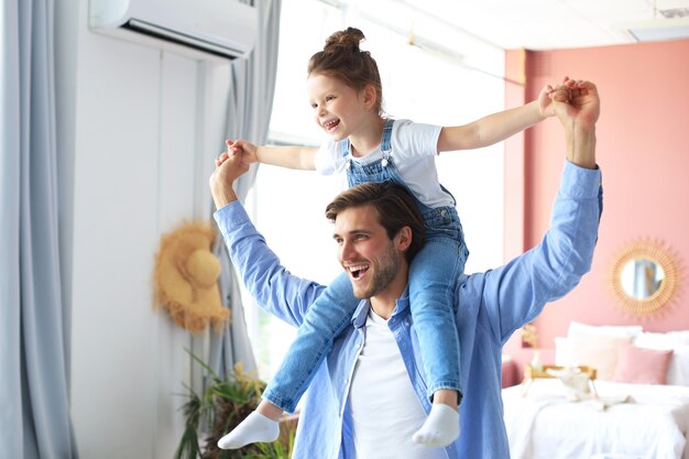 Photo father and his daughter child girl playing together. father's day concept.