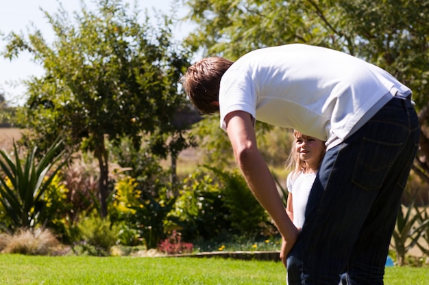 Father and his daughter in a park