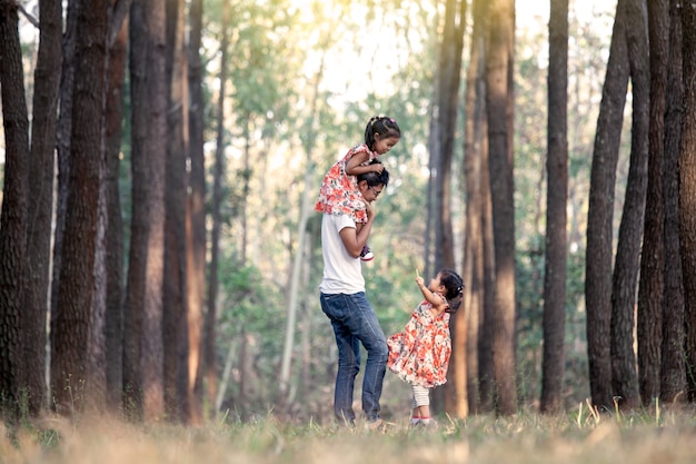 Father and his daughters having fun playing in the park