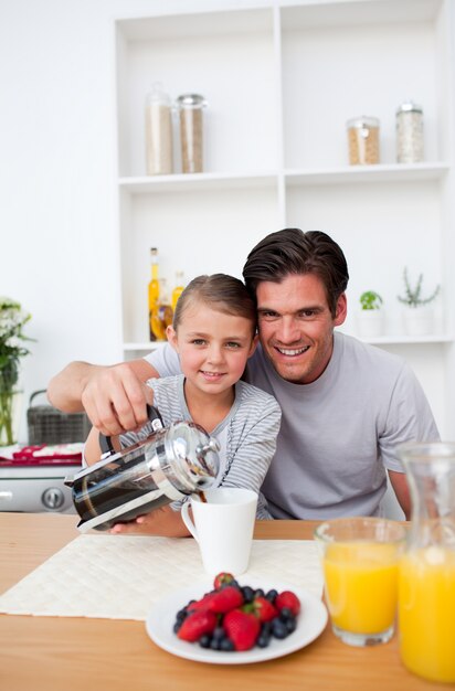 Father and his little girl having breakfast