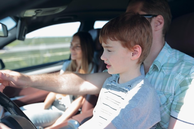 Father and his little son driving a car the concept of parenting