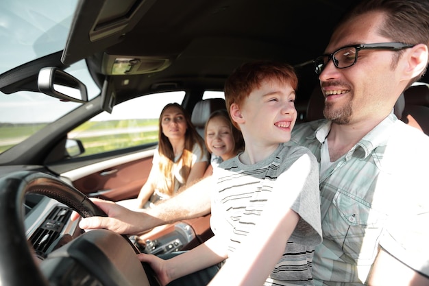 Father and his little son driving a car