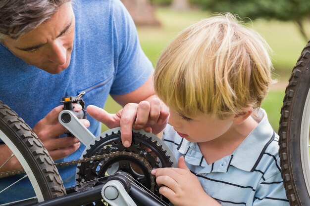 Father and his son fixing a bike 