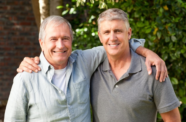 Father and his son looking at the camera in the garden