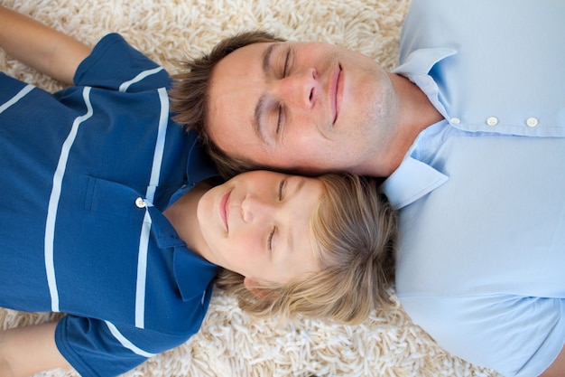 Father and his son lying on the floor 