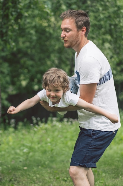 Father and his son playing and hugging in outdoors