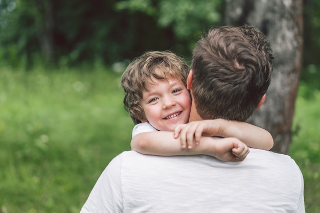 Father and his son playing and hugging in outdoors