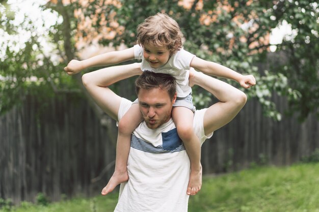 Father and his son playing and hugging in outdoors