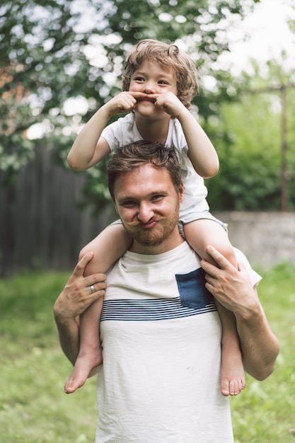 Father and his son playing and hugging in outdoors