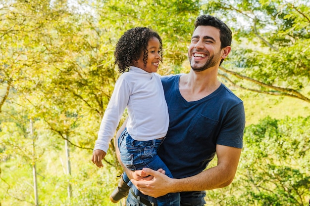 Father holding daughter