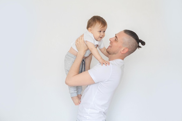 Photo father holding his son in his arms and smiling