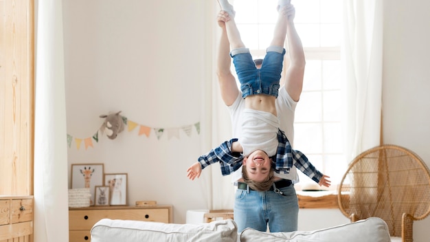 Father holding his son upside down long shot