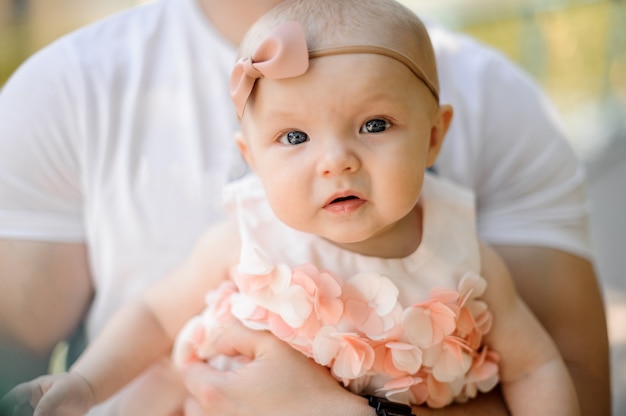 Father holding little cute daughter on his hands