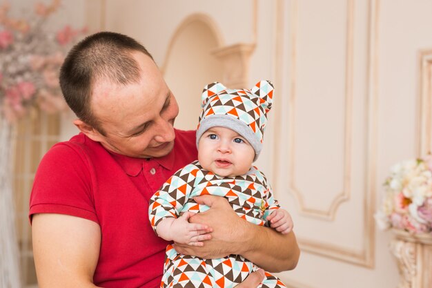 Father holding and playing his little baby child son.