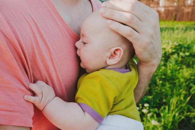 Father holds a baby in his arms