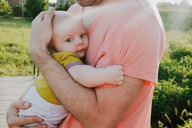 Father holds a baby in his arms