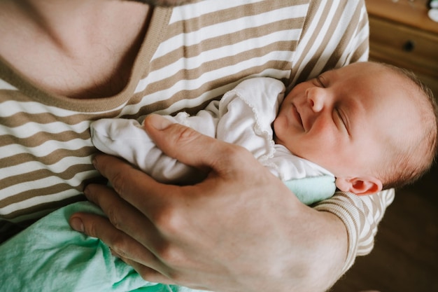 Father holds a baby in his arms