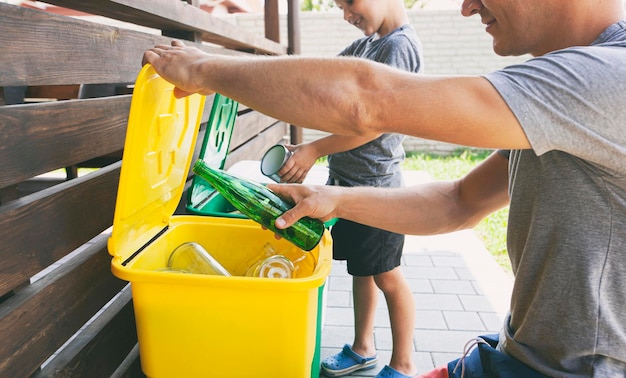 The father is teaching her son how to sorting trash