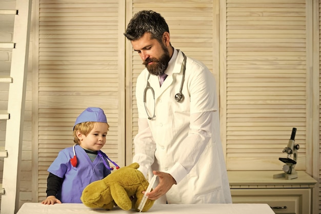 Father and kid with busy faces play doctor