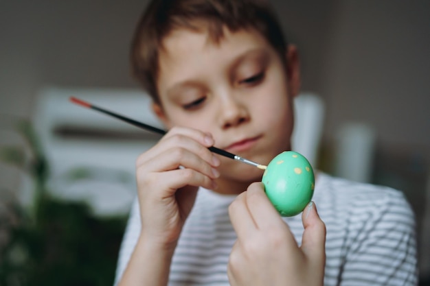 father and kids colouring eggs for easter Image with selective focus