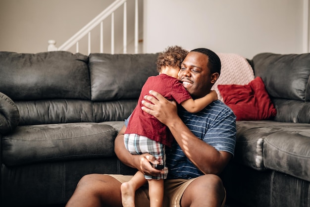 father and kids at home playing on couch african american or black father with his children enjoy