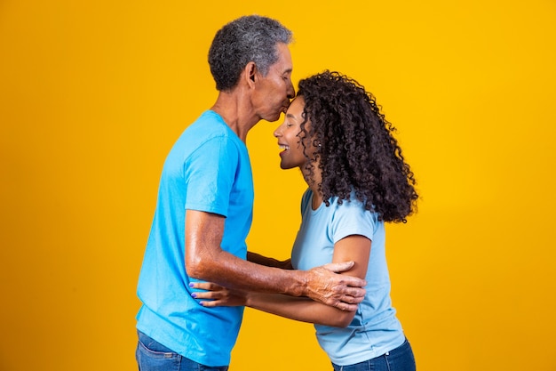 Father kisses his daughter's forehead