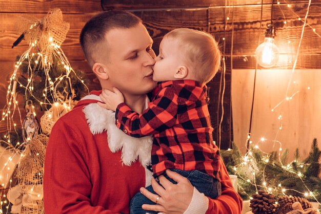 Father kissing son. Winter holidays concept. Magic atmosphere family holidays. Fatherhood joy. Enjoy