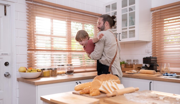 Father in the kitchen of the house with a small child Play and have fun cooking dinner together