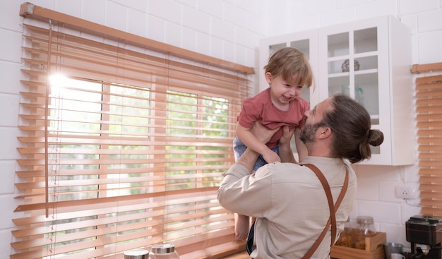 Father in the kitchen of the house with a small child Play and have fun cooking dinner together